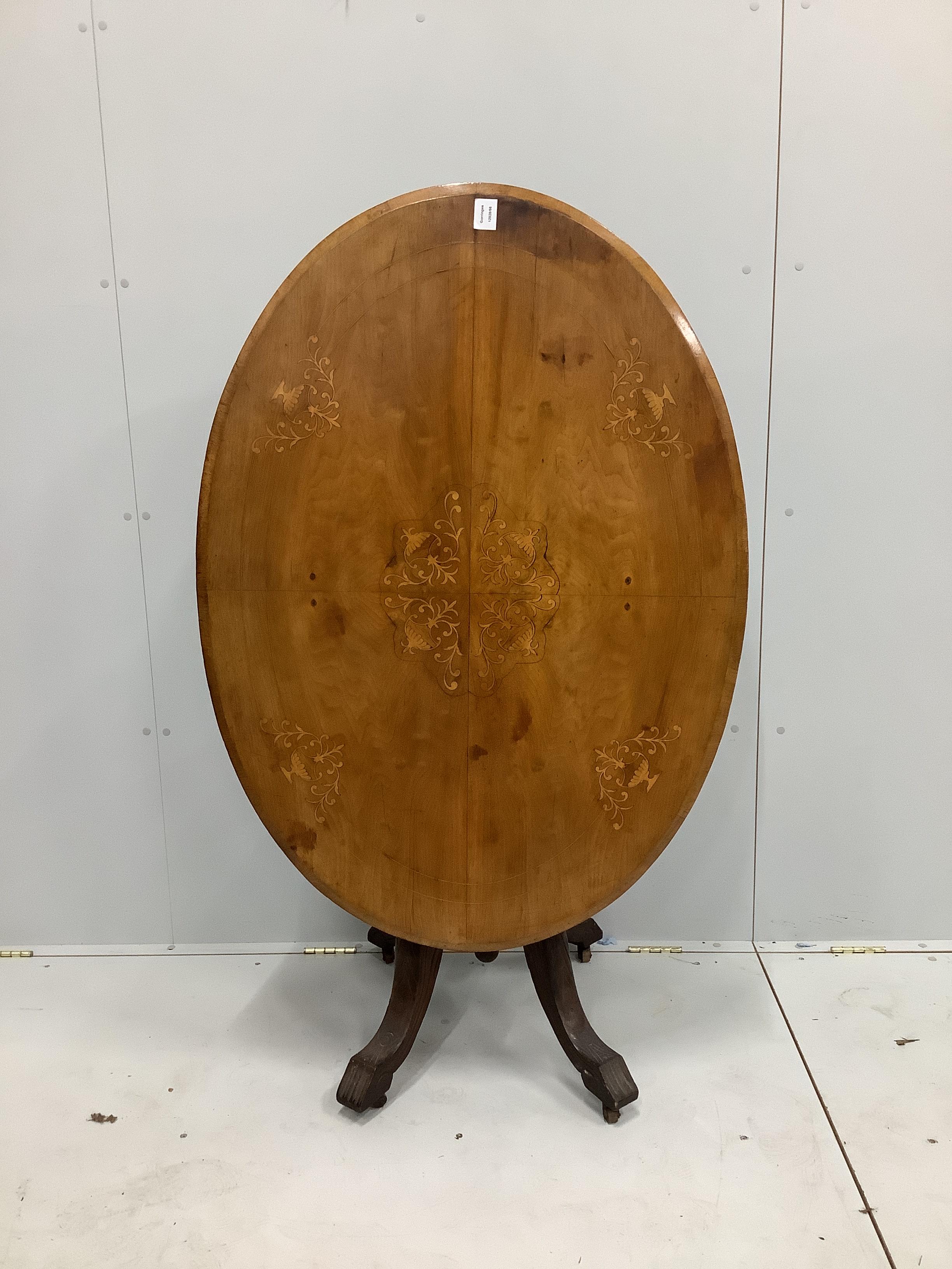 A late Victorian oval inlaid walnut tilt top loo table, length 116cm, width 84cm, height 72cm